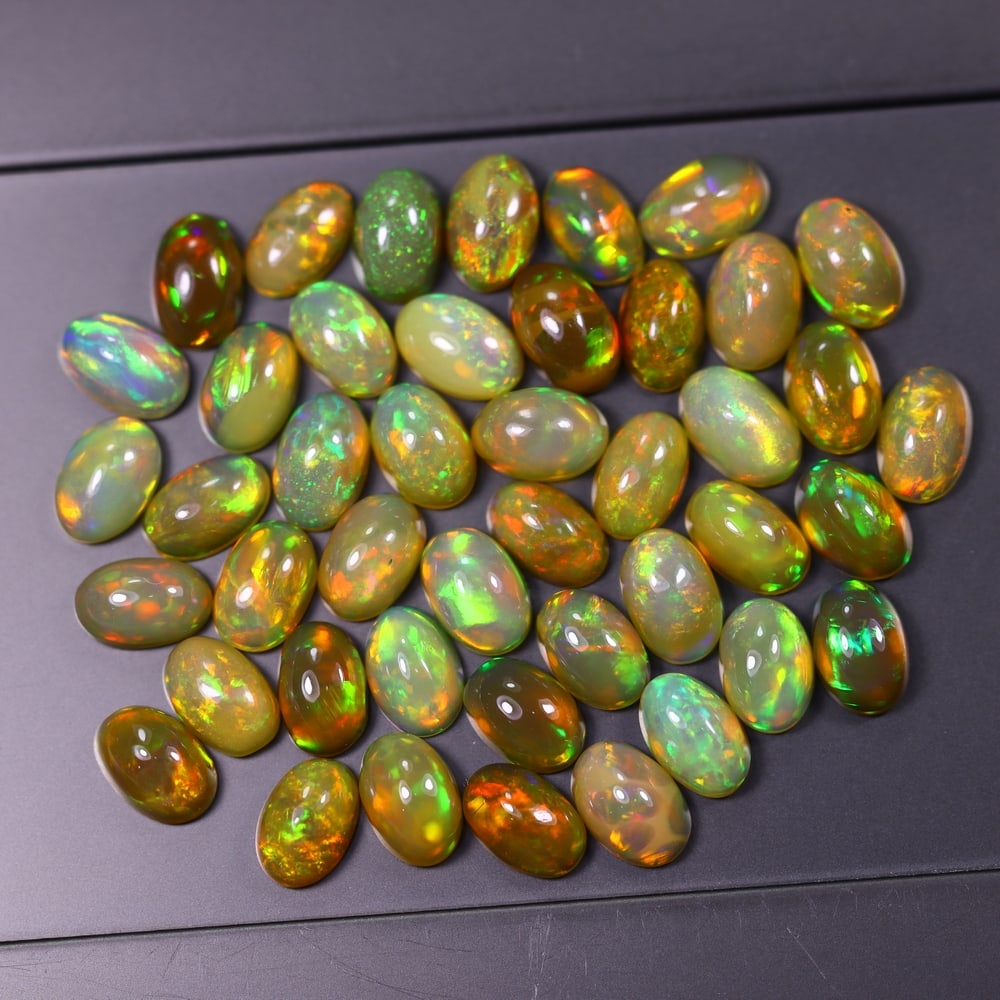 *15.91Ct 6x4mm Welo Opal Lot - Ethiopian Opal, 373C: Ksmith Heritage Auctioneers Subject: Natural Ethiopian Welo Opal Origin: Ethiopia Carat Weight: 15.91Ct Dimension: 6x4x2.6 mm Treatment: Natural Untreated Type: Cabochon, Polis