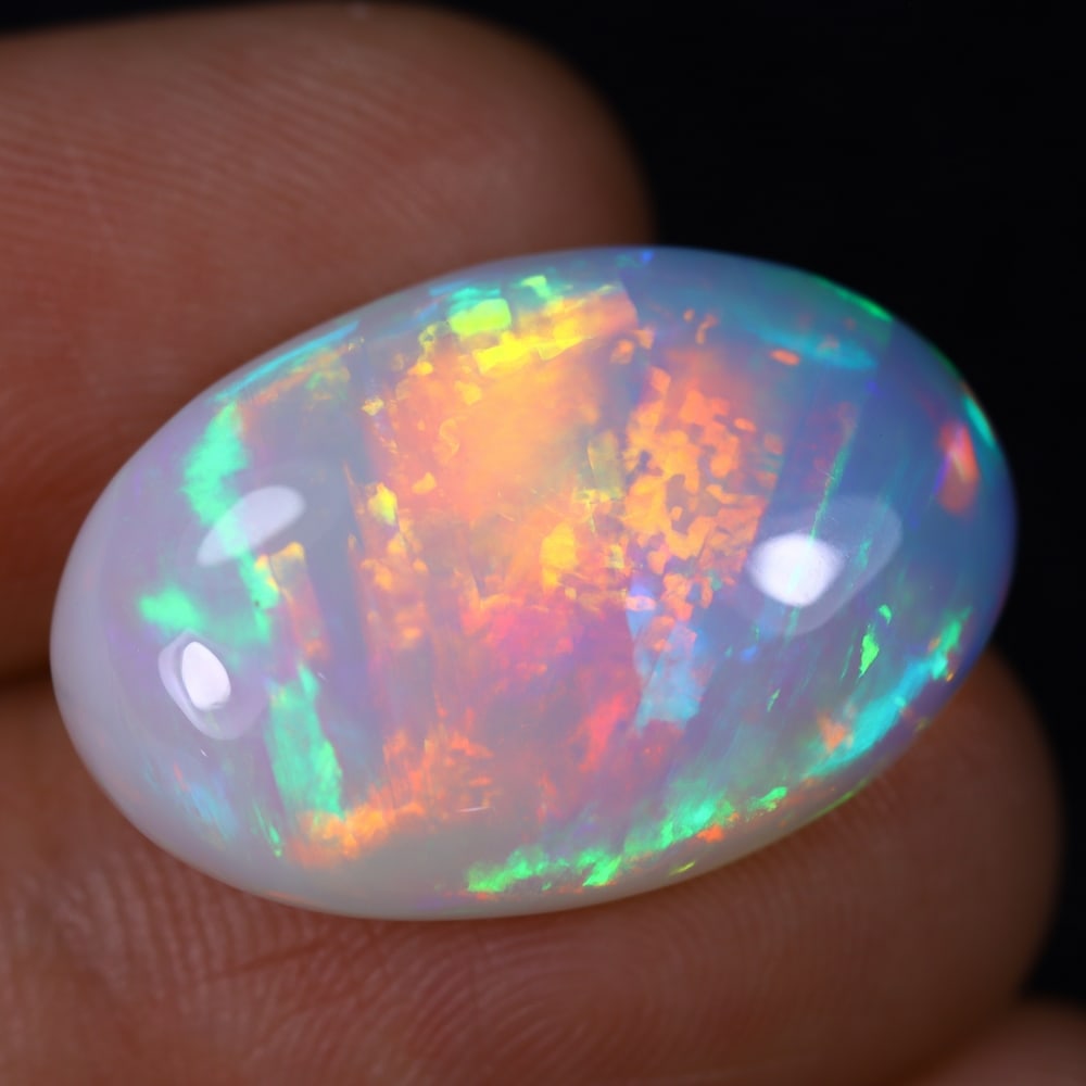 *12.84Ct Welo Opal Polished - Ethiopian Opal, 939B: Ksmith Heritage Auctioneers Subject: Natural Ethiopian Welo Opal Origin: Ethiopia Carat Weight: 12.84Ct Dimension: 22.6x15x7.1 mm Treatment: Natural Untreated Type: Cabochon, P