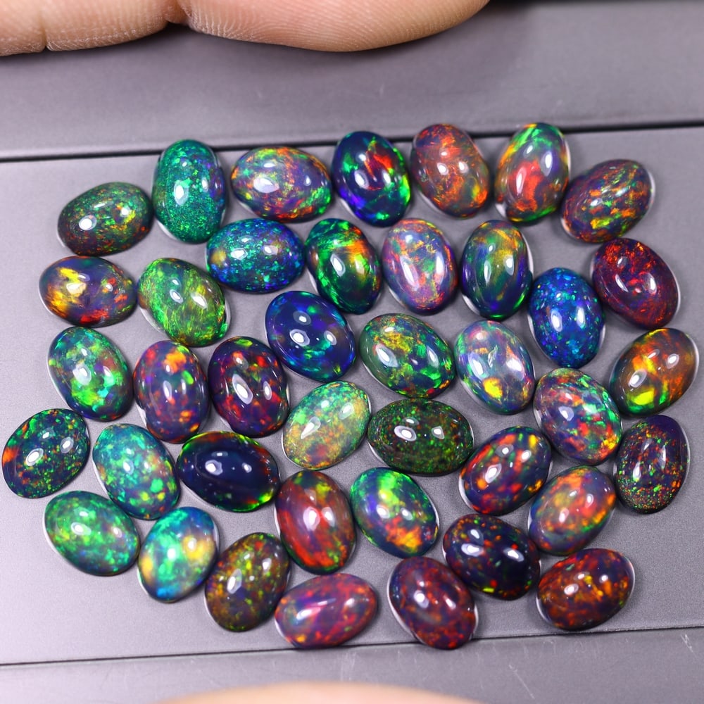 *20.18Ct 7x5mm Smoked Welo Opal Lot - Ethiopian Opal, 362C: Ksmith Heritage Auctioneers Subject: Natural Ethiopian Welo Opal Origin: Ethiopia Carat Weight: 20.18Ct Dimension: 7x5x2.6 mm Treatment: Smoked Type: Cabochon, Polished