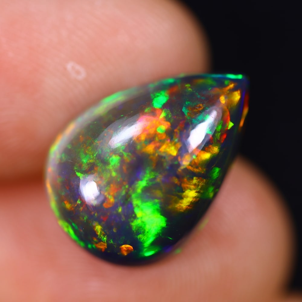 *5.06Ct Welo Black Opal Polished - Ethiopian Opal - Pear Cabochon , 358E: Ksmith Heritage Auctioneers Subject: Natural Ethiopian Welo Black Opal Origin: Ethiopia Carat Weight: 5.06Ct Dimension: 16.2x11.4x5.9 mm Treatment: Smoked Shape: Pear <