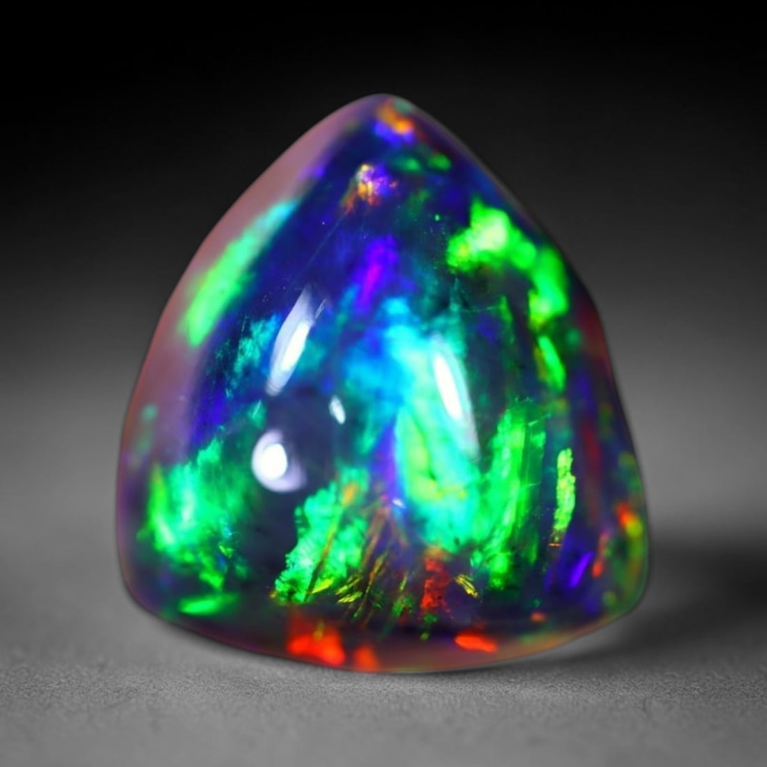 *4.76Ct Welo Black Opal Polished - Ethiopian Opal - Triangle Cabochon , 300E: Ksmith Heritage Auctioneers Subject: Natural Ethiopian Welo Black Opal Origin: Ethiopia Carat Weight: 4.76Ct Dimension: 12.5 x 11.7 x 7.6 mm Treatment: Smoked Shape: Trian