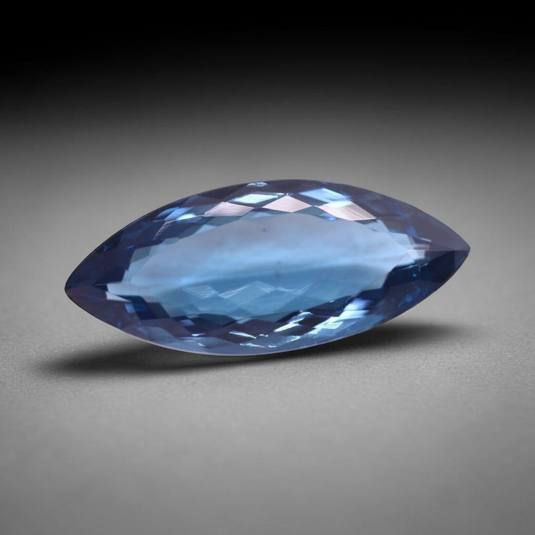 *25.74Ct London Blue Topaz - Polished Faceted , 211C: Ksmith Heritage Auctioneers Subject: Natural Blue Topaz Origin: Myanmar Carat Weight: 25.74Ct Dimension: 30.4x12.8x7.9 mm Treatment: Irridiated Type: Faceted, Polished