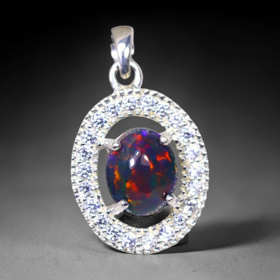 Silver Pendant with Ethiopian Black Opal 3.5grams - 925 Sterling Silver, 455B: Ksmith Heritage Auctioneers Subject: Opal & Simulated Diamond Silver Pendant Carat Weight: 3.5 grams (approx.) Dimension: Opal 10x7mm, Pendant 22x15mm