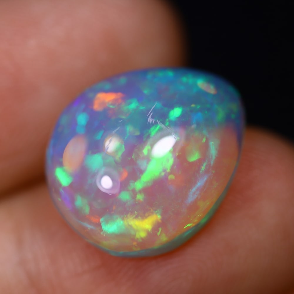 7.47Ct Welo Opal Polished - Ethiopian Opal - Pear Cabochon, 1093B: Ksmith Heritage Auctioneers Subject: Natural Ethiopian Welo Opal Origin: Ethiopia Carat Weight: 7.47Ct Dimension: 16.1 x 13.5 x 6.7 mm Treatment: Natural Untreated Shape: Pear