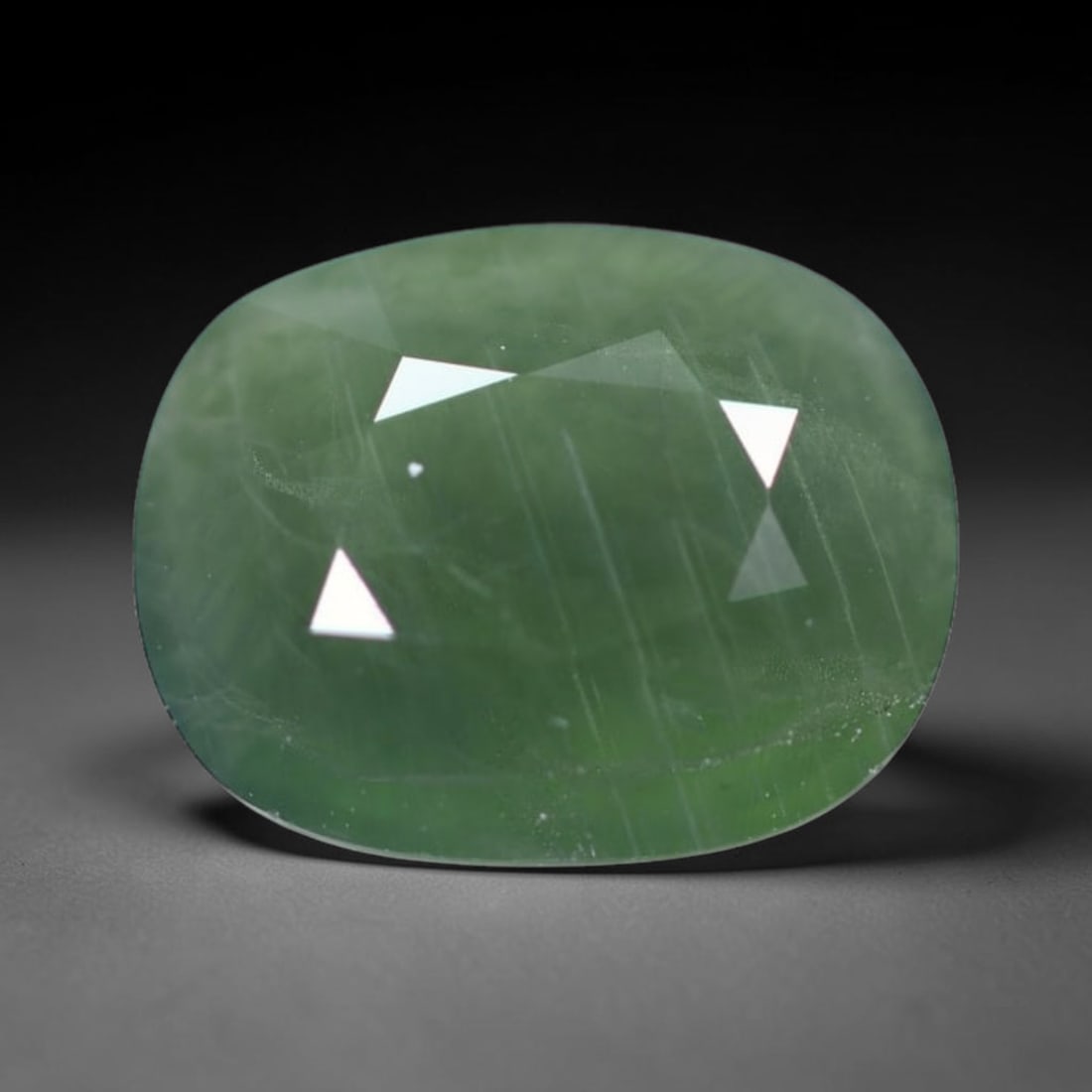 *4.36Ct Heated Green Sapphire - Polished Faceted , 317C: Ksmith Heritage Auctioneers Subject: Natural Sapphire Carat Weight: 4.36Ct Dimension: 10.5x8.3x5.1 mm Treatment: Heated Type: Faceted, Polished