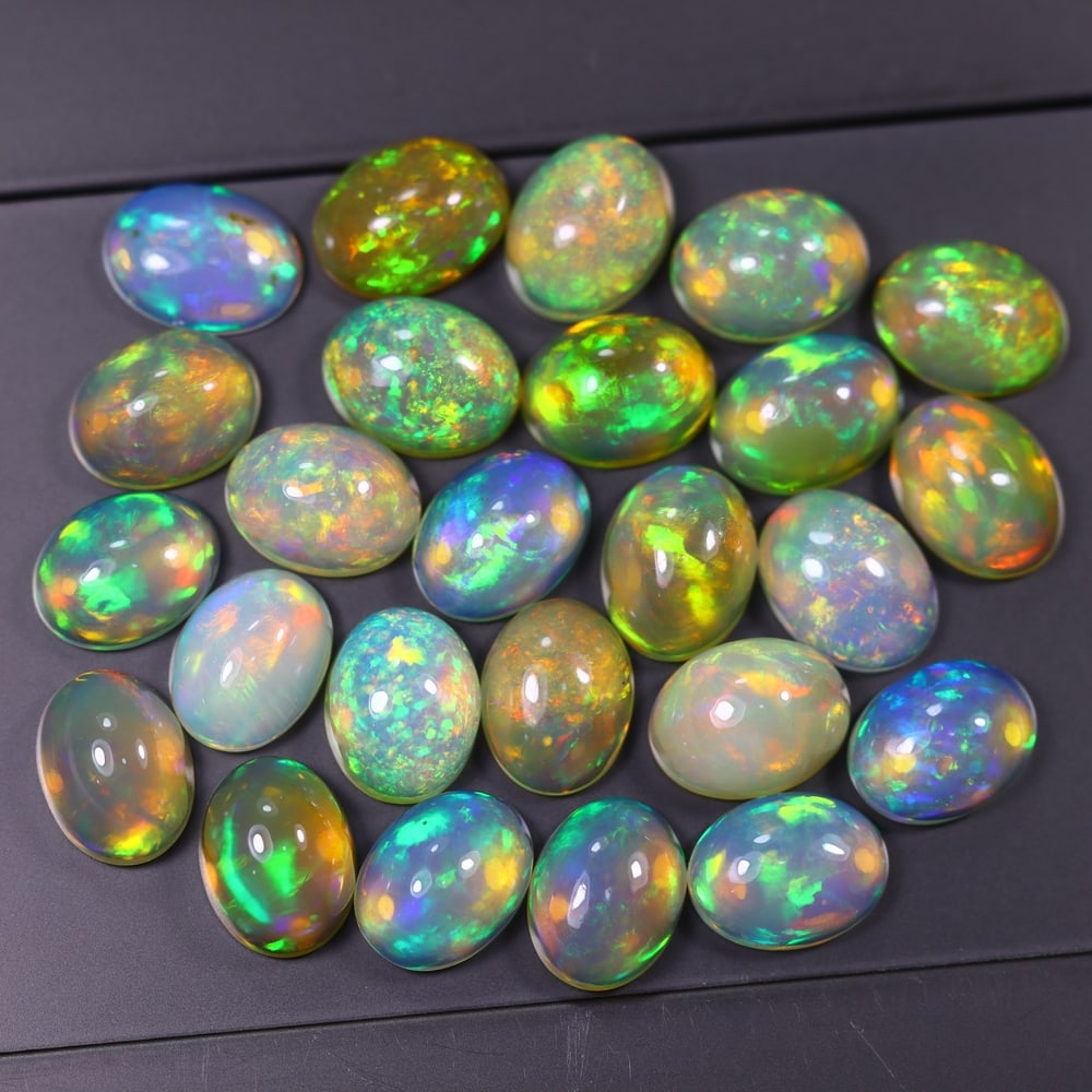 *22.71Ct 8x6mm Welo Opal Lot - Ethiopian Opal, 366C: Ksmith Heritage Auctioneers Subject: Natural Ethiopian Welo Opal Origin: Ethiopia Carat Weight: 22.71Ct Dimension: 8x6x4.4 mm Treatment: Natural Untreated Type: Cabochon, Polished