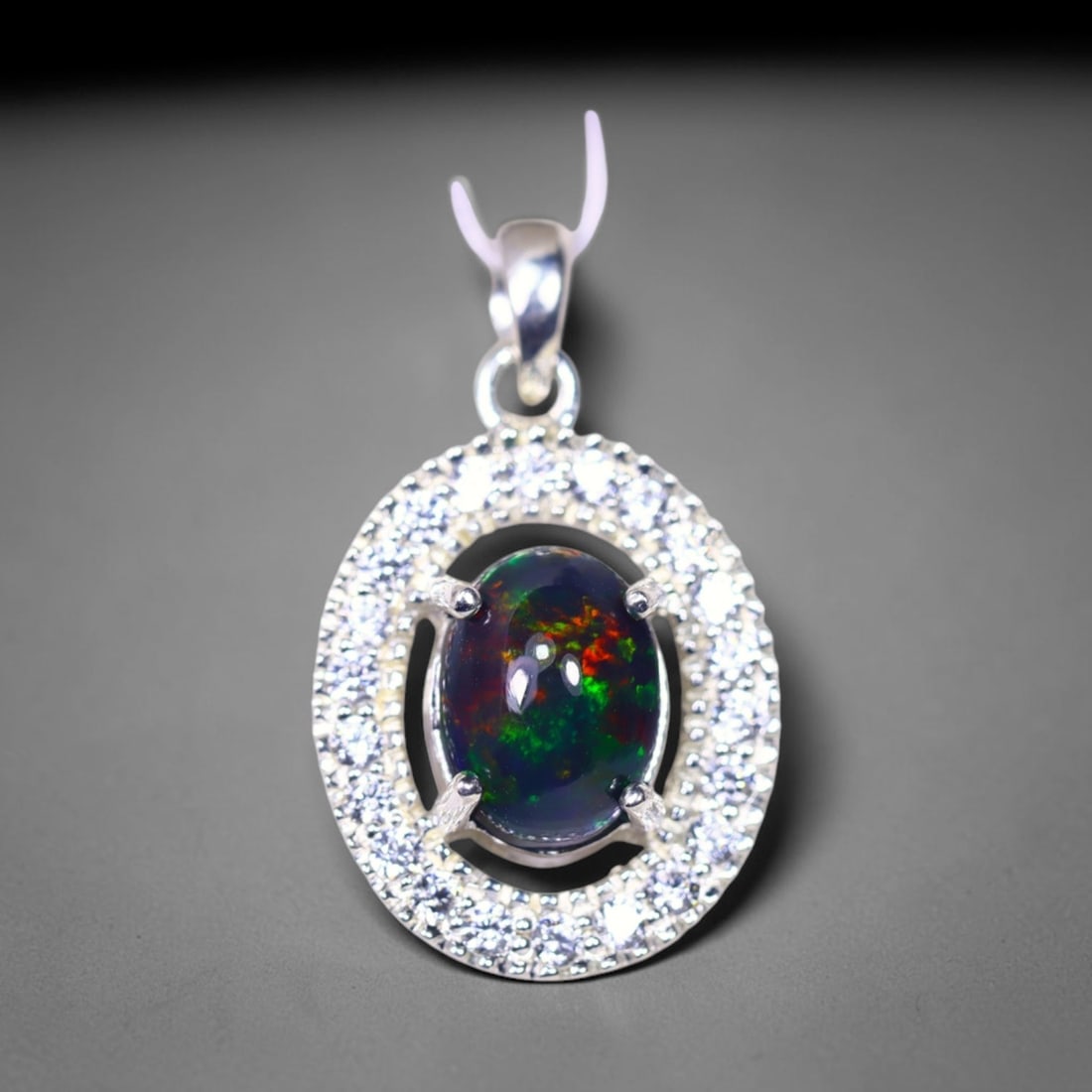 Silver Pendant with Ethiopian Black Opal 3.5grams - 925 Sterling Silver , 856E: Ksmith Heritage Auctioneers Subject: Opal & Simulated Diamond Silver Pendant Carat Weight: 3.5 grams (approx.) Dimension: Opal 10x7mm, Pendant 22x15mm