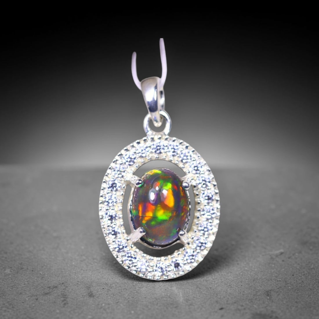 Silver Pendant with Ethiopian Black Opal 3.5grams - 925 Sterling Silver , 55E: Ksmith Heritage Auctioneers Subject: Opal & Simulated Diamond Silver Pendant Carat Weight: 3.5 grams (approx.) Dimension: Opal 10x7mm, Pendant 22x15mm