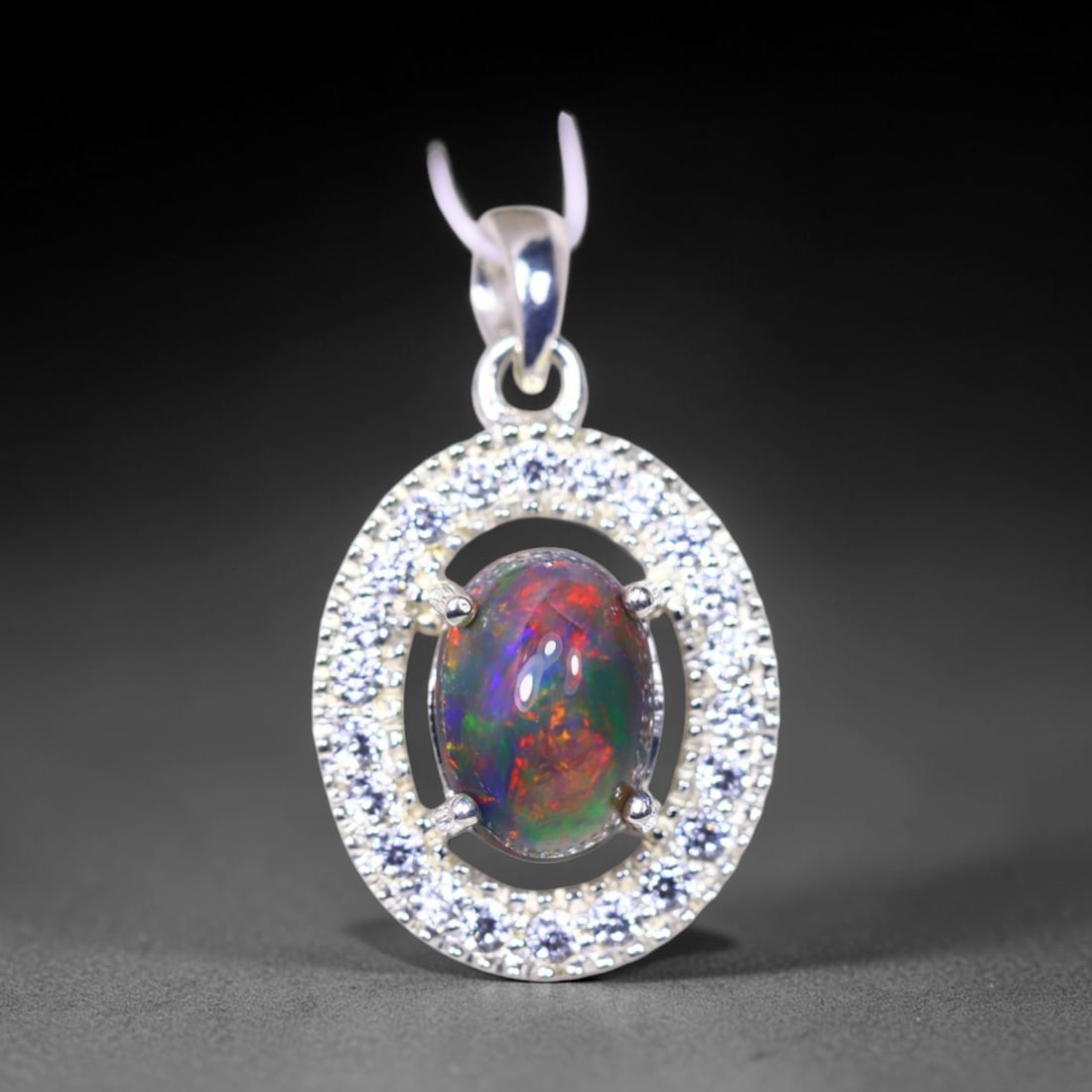 Silver Pendant with Ethiopian Black Opal 3.5grams - 925 Sterling Silver , 944E: Ksmith Heritage Auctioneers Subject: Opal & Simulated Diamond Silver Pendant Carat Weight: 3.5 grams (approx.) Dimension: Opal 10x7mm, Pendant 22x15mm