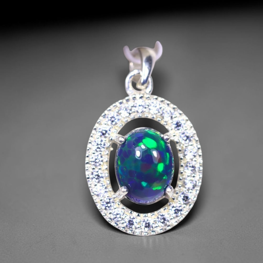 Silver Pendant with Ethiopian Black Opal 3.5grams - 925 Sterling Silver , 227E: Ksmith Heritage Auctioneers Subject: Opal & Simulated Diamond Silver Pendant Carat Weight: 3.5 grams (approx.) Dimension: Opal 10x7mm, Pendant 22x15mm