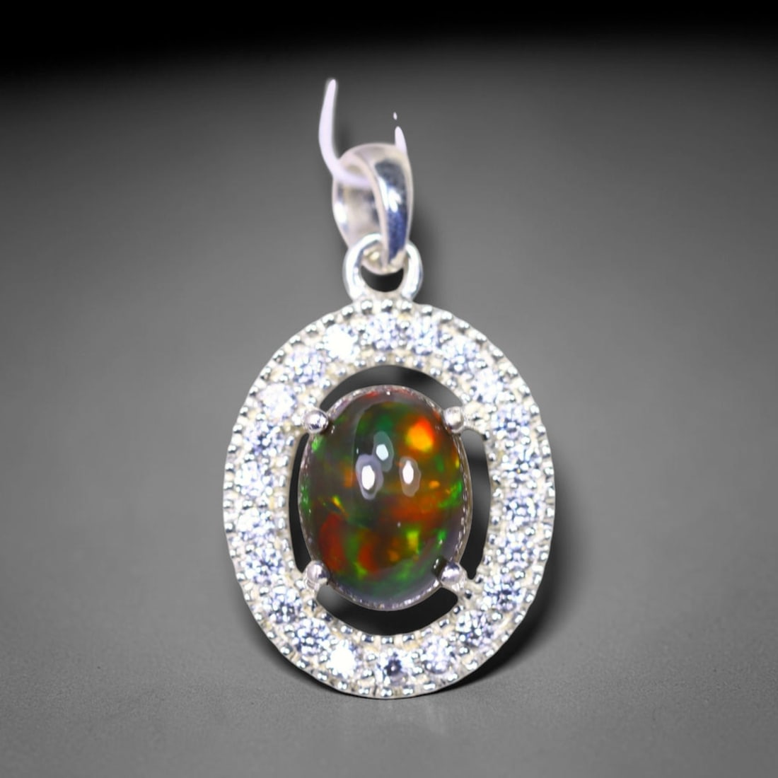 Silver Pendant with Ethiopian Black Opal 3.5grams - 925 Sterling Silver , 678E: Ksmith Heritage Auctioneers Subject: Opal & Simulated Diamond Silver Pendant Carat Weight: 3.5 grams (approx.) Dimension: Opal 10x7mm, Pendant 22x15mm