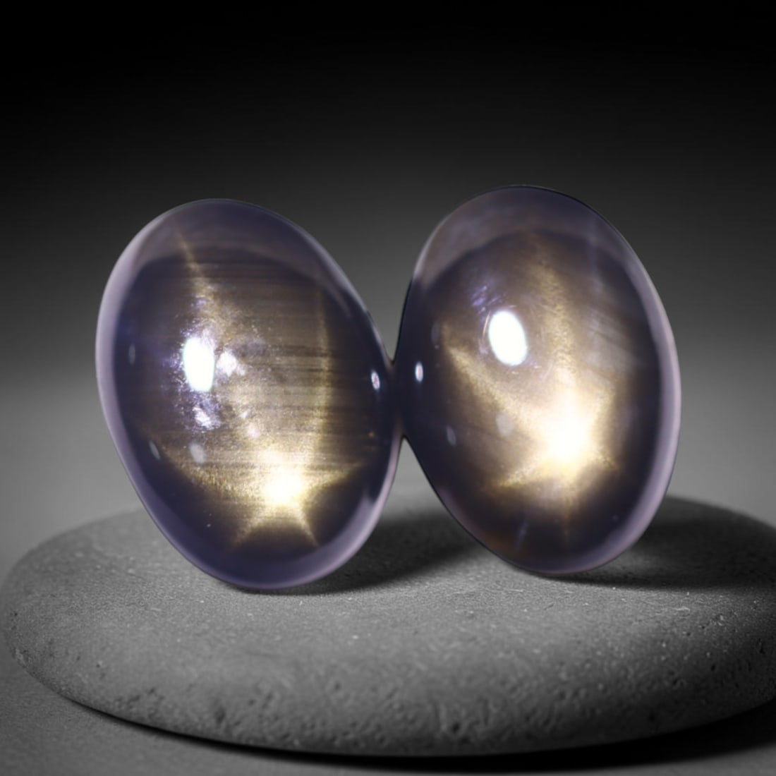 2.05cts 6 Rays Black Star Sapphire Pair , 618E: Ksmith Heritage Auctioneers Subject: Natural 6 Rays Star Sapphire Origin: Myanmar Carat Weight: 2.05cts Dimension: 7.1x5.2x2.5 mm Treatment: Diffusion Type: Cabochon, Poli