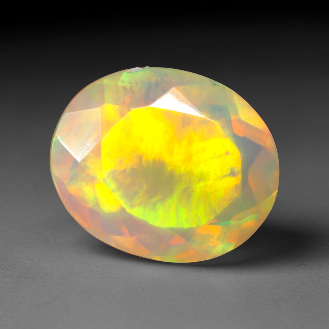 3.15Ct Natural Ethiopian Opal, Faceted Cut - 12.0x9.8x6.2 mm , 653C: Ksmith Heritage Auctioneers Subject: Natural Ethiopian Welo Opal Origin: Ethiopia Treatment: Unheated