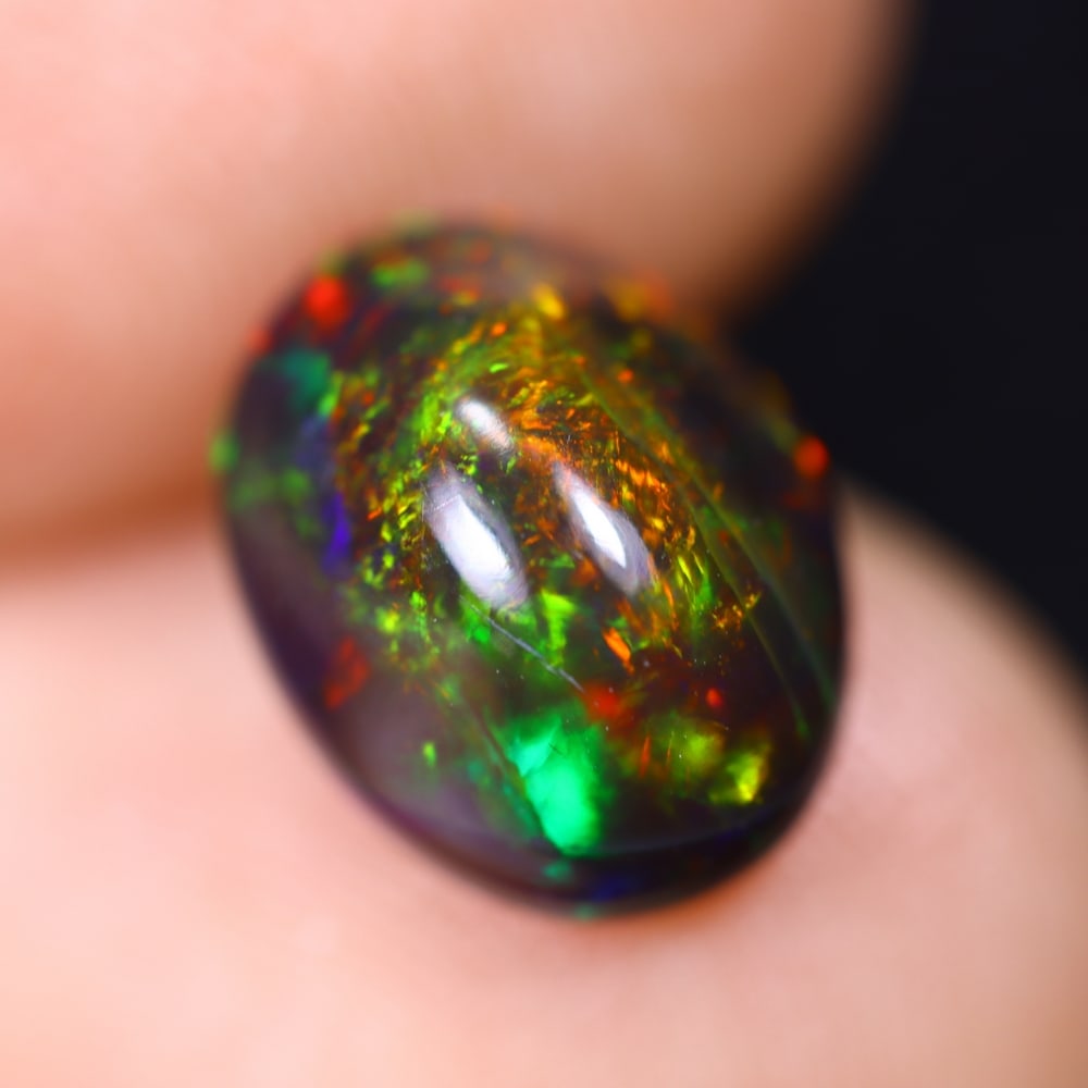 1.68Ct Welo Black Opal Polished - Ethiopian Opal , 1169E: Ksmith Heritage Auctioneers Subject: Natural Ethiopian Welo Black Opal Origin: Ethiopia Carat Weight: 1.68Ct Dimension: 10.1x7.9x4.7 mm Treatment: Smoked Type: Cabochon, P