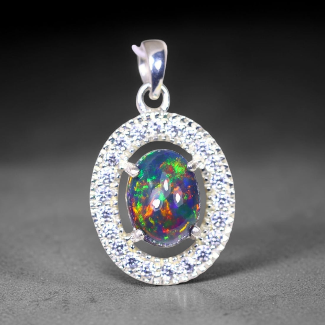 Silver Pendant with Ethiopian Black Opal 3.5grams - 925 Sterling Silver , 571E: Ksmith Heritage Auctioneers Subject: Opal & Simulated Diamond Silver Pendant Carat Weight: 3.5 grams (approx.) Dimension: Opal 10x7mm, Pendant 22x15mm