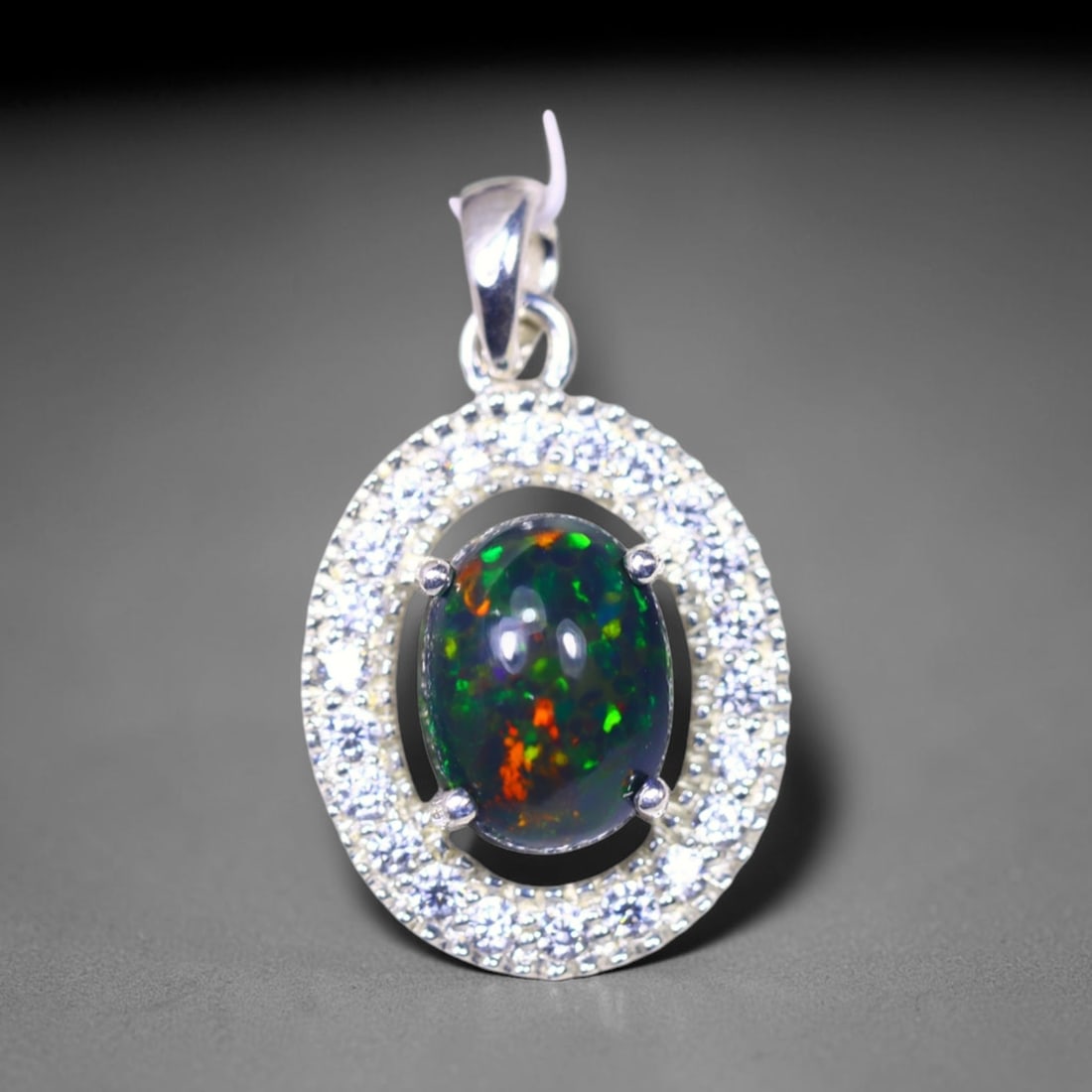 Silver Pendant with Ethiopian Black Opal 3.5grams - 925 Sterling Silver , 775E: Ksmith Heritage Auctioneers Subject: Opal & Simulated Diamond Silver Pendant Carat Weight: 3.5 grams (approx.) Dimension: Opal 10x7mm, Pendant 22x15mm