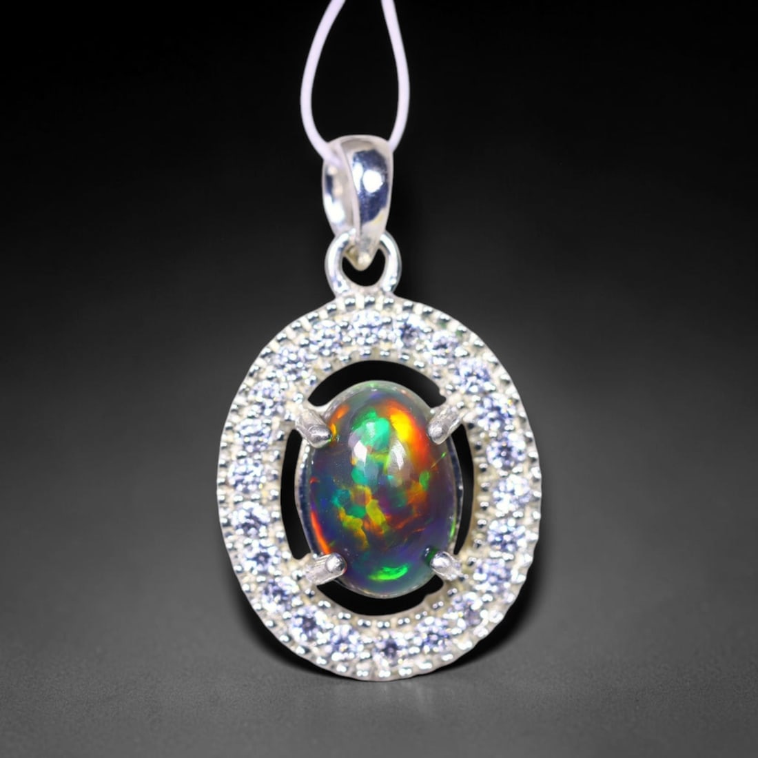 Silver Pendant with Ethiopian Black Opal 3.5grams - 925 Sterling Silver , 360E: Ksmith Heritage Auctioneers Subject: Opal & Simulated Diamond Silver Pendant Carat Weight: 3.5 grams (approx.) Dimension: Opal 10x7mm, Pendant 22x15mm