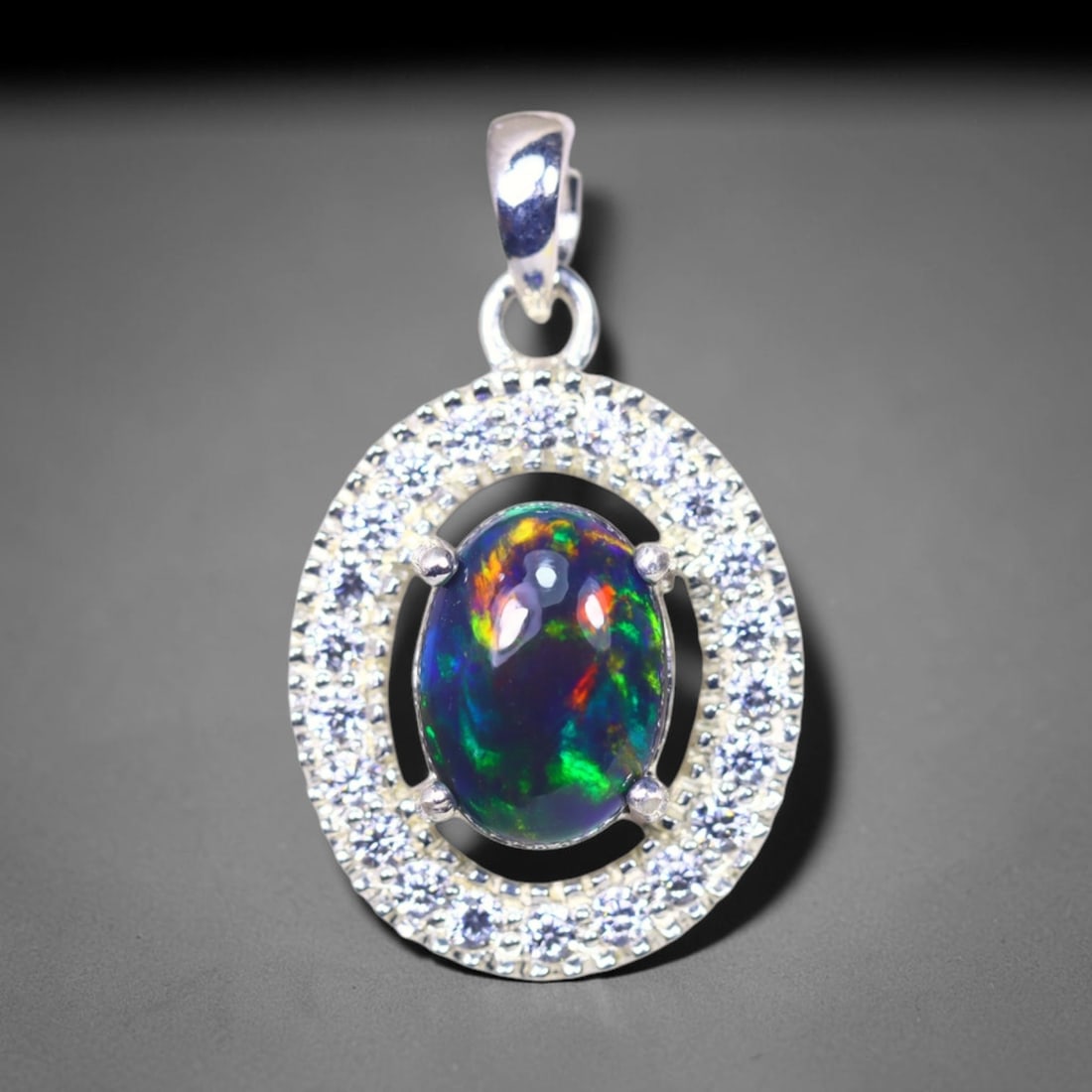 Silver Pendant with Ethiopian Black Opal 3.5grams - 925 Sterling Silver , 755E: Ksmith Heritage Auctioneers Subject: Opal & Simulated Diamond Silver Pendant Carat Weight: 3.5 grams (approx.) Dimension: Opal 10x7mm, Pendant 22x15mm