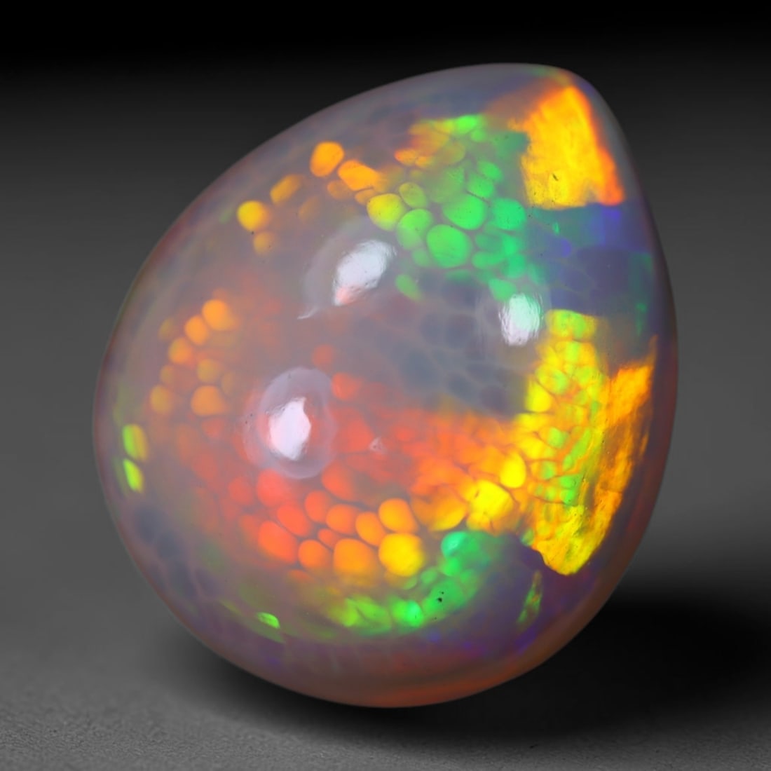 *10.87Ct Welo Opal Polished - Ethiopian Opal, 1128B: Ksmith Heritage Auctioneers Subject: Natural Ethiopian Welo Opal Origin: Ethiopia Carat Weight: 10.87Ct Dimension: 17.7x15x8.6 mm Treatment: Natural Untreated Type: Cabochon, P