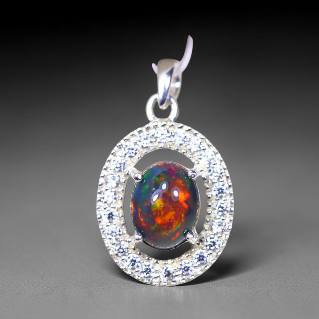 Silver Pendant with Ethiopian Black Opal 3.5grams - 925 Sterling Silver, 304B: Ksmith Heritage Auctioneers Subject: Opal & Simulated Diamond Silver Pendant Carat Weight: 3.5 grams (approx.) Dimension: Opal 10x7mm, Pendant 22x15mm