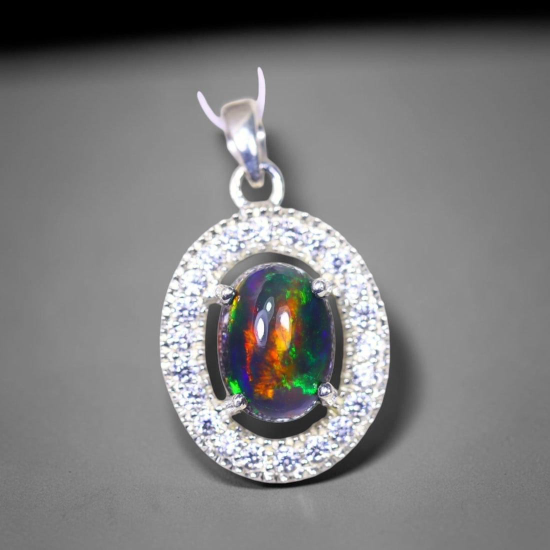 Silver Pendant with Ethiopian Black Opal 3.5grams - 925 Sterling Silver, 33B: Ksmith Heritage Auctioneers Subject: Opal & Simulated Diamond Silver Pendant Carat Weight: 3.5 grams (approx.) Dimension: Opal 10x7mm, Pendant 22x15mm