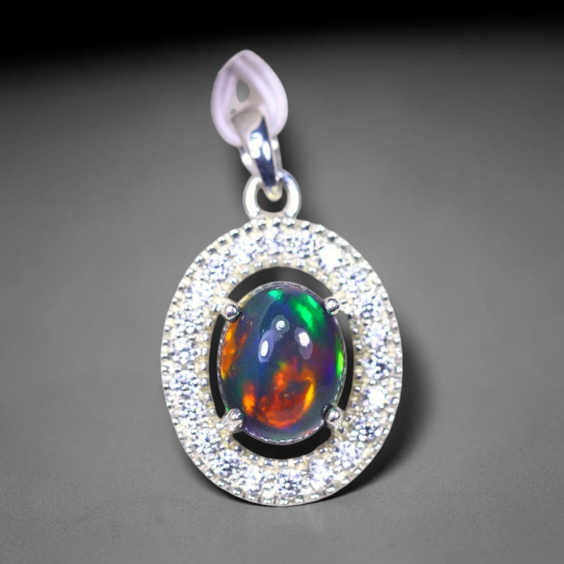 Silver Pendant with Ethiopian Black Opal 3.5grams - 925 Sterling Silver , 694E: Ksmith Heritage Auctioneers Subject: Opal & Simulated Diamond Silver Pendant Carat Weight: 3.5 grams (approx.) Dimension: Opal 10x7mm, Pendant 22x15mm