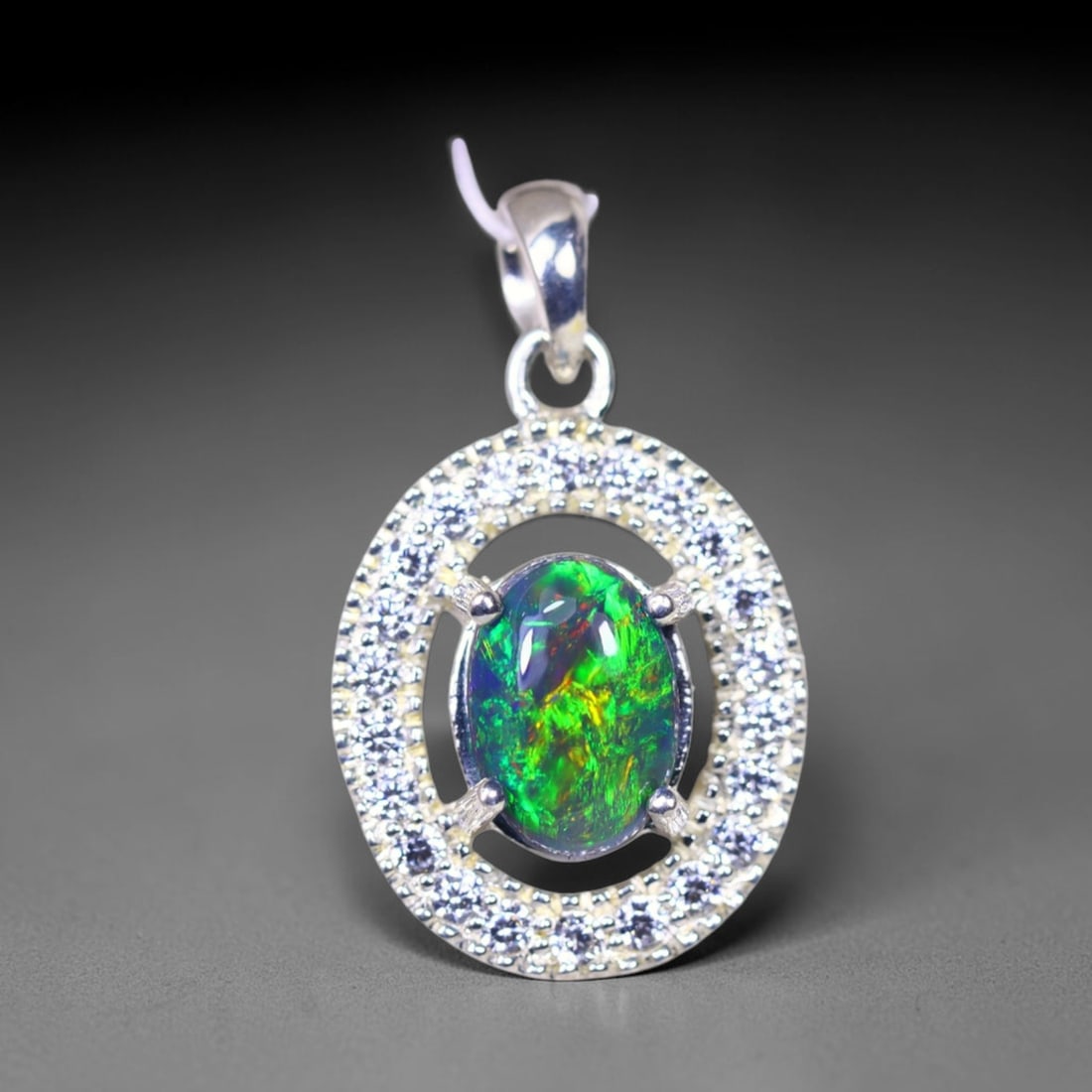Silver Pendant with Ethiopian Black Opal 3.5grams - 925 Sterling Silver , 242E: Ksmith Heritage Auctioneers Subject: Opal & Simulated Diamond Silver Pendant Carat Weight: 3.5 grams (approx.) Dimension: Opal 10x7mm, Pendant 22x15mm