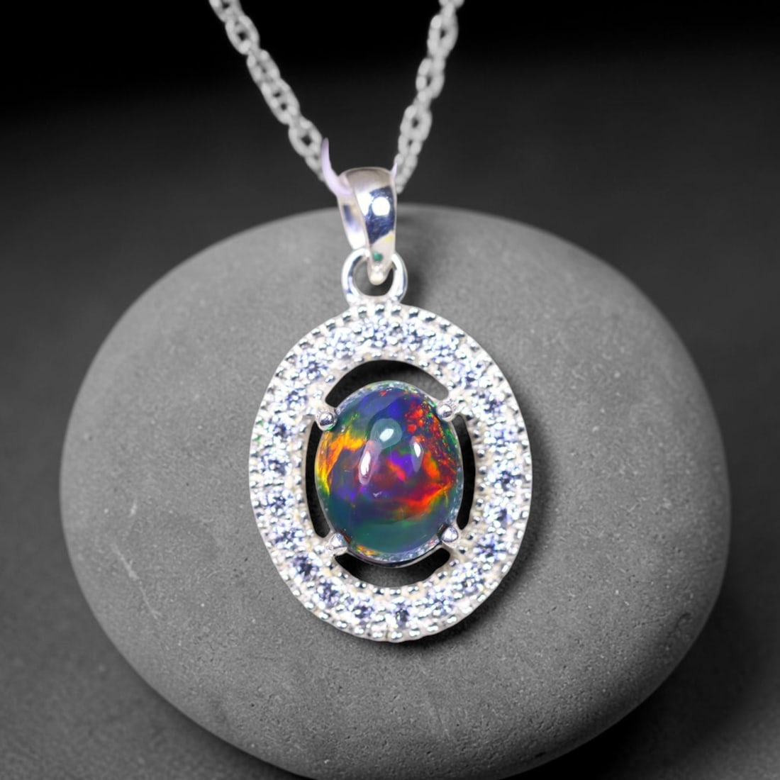 Silver Pendant with Ethiopian Black Opal 3.5grams - 925 Sterling Silver, 92B: Ksmith Heritage Auctioneers Subject: Opal & Simulated Diamond Silver Pendant Carat Weight: 3.5 grams (approx.) Dimension: Opal 10x7mm, Pendant 22x15mm