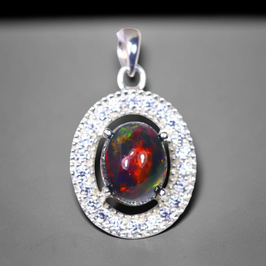 Silver Pendant with Ethiopian Black Opal 3.5grams - 925 Sterling Silver, 954B: Ksmith Heritage Auctioneers Subject: Opal & Simulated Diamond Silver Pendant Carat Weight: 3.5 grams (approx.) Dimension: Opal 10x7mm, Pendant 22x15mm