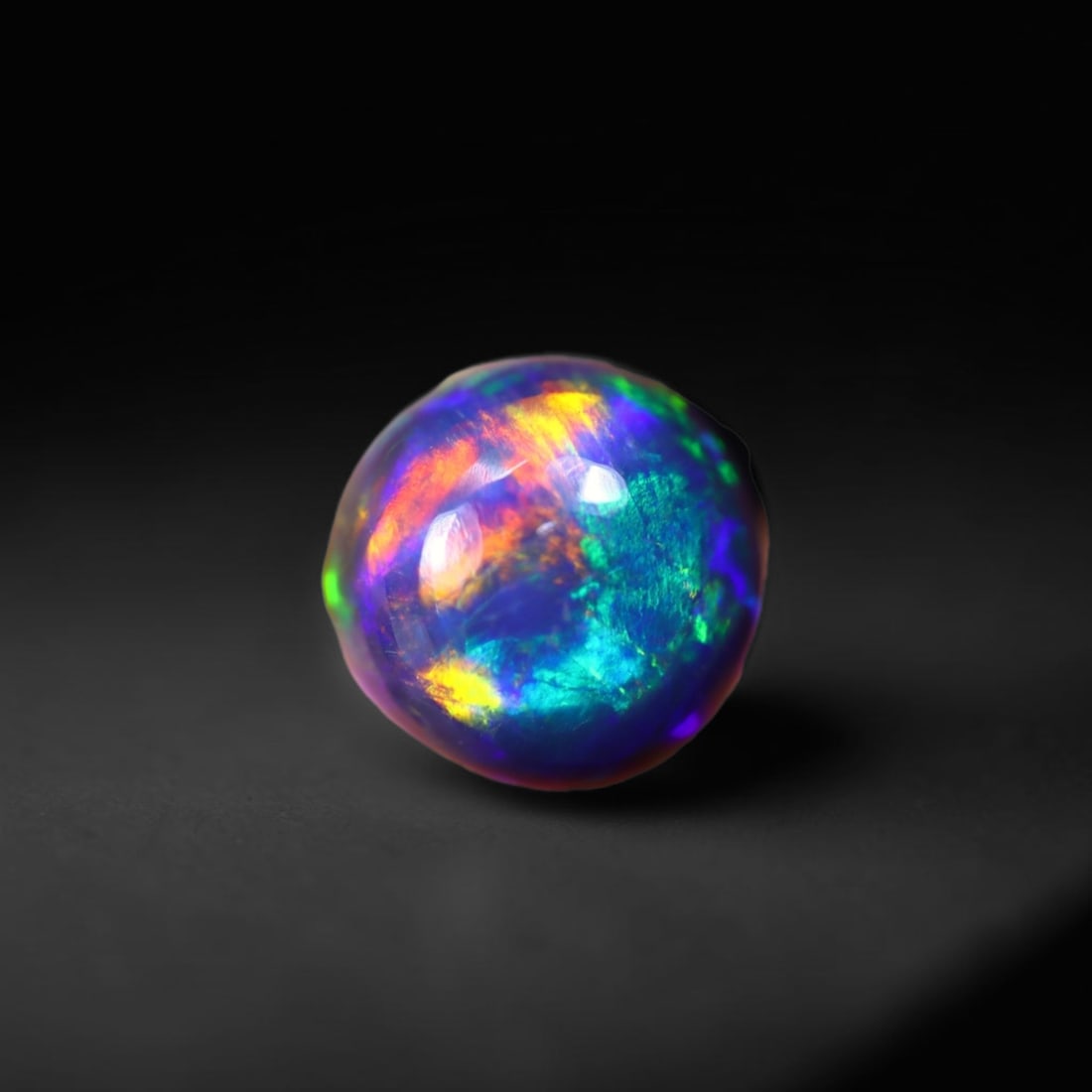 *1.37Ct Smoked Welo Opal Polished - Ethiopian Opal , 302C: Ksmith Heritage Auctioneers Subject: Natural Ethiopian Welo Opal Origin: Ethiopia Carat Weight: 1.37Ct Dimension: 8.2x8.1x4 mm Treatment: Smoked Type: Cabochon, Polished
