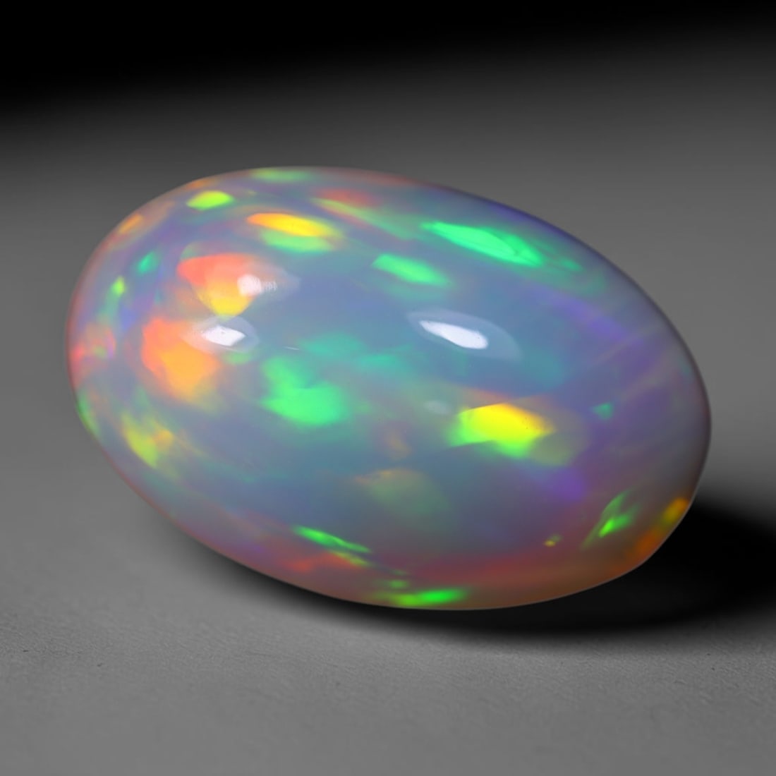 *10.83Ct Welo Opal Polished - Ethiopian Opal, 1154B: Ksmith Heritage Auctioneers Subject: Natural Ethiopian Welo Opal Origin: Ethiopia Carat Weight: 10.83Ct Dimension: 19x12.3x9.4 mm Treatment: Natural Untreated Type: Cabochon, P