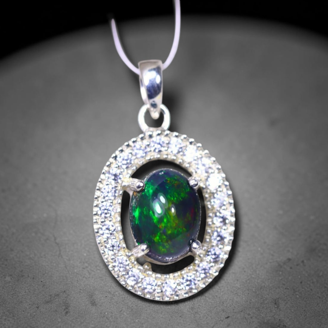 Silver Pendant with Ethiopian Black Opal 3.5grams - 925 Sterling Silver , 164E: Ksmith Heritage Auctioneers Subject: Opal & Simulated Diamond Silver Pendant Carat Weight: 3.5 grams (approx.) Dimension: Opal 10x7mm, Pendant 22x15mm