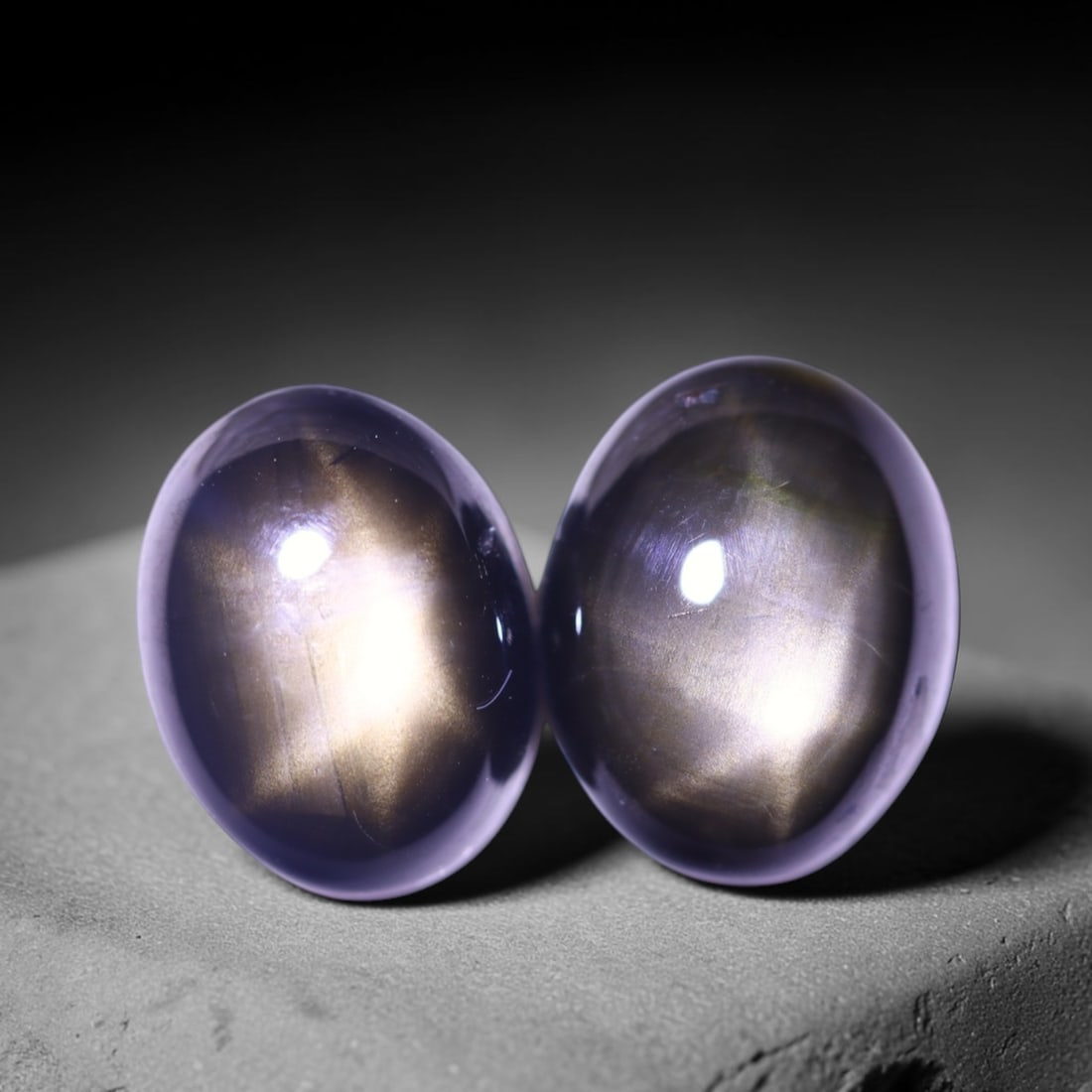 4.61cts 6 Rays Black Star Sapphire Pair , 1218E: Ksmith Heritage Auctioneers Subject: Natural 6 Rays Star Sapphire Origin: Myanmar Carat Weight: 4.61cts Dimension: 8.3x6.3x3.8 mm Treatment: Diffusion Type: Cabochon, Poli
