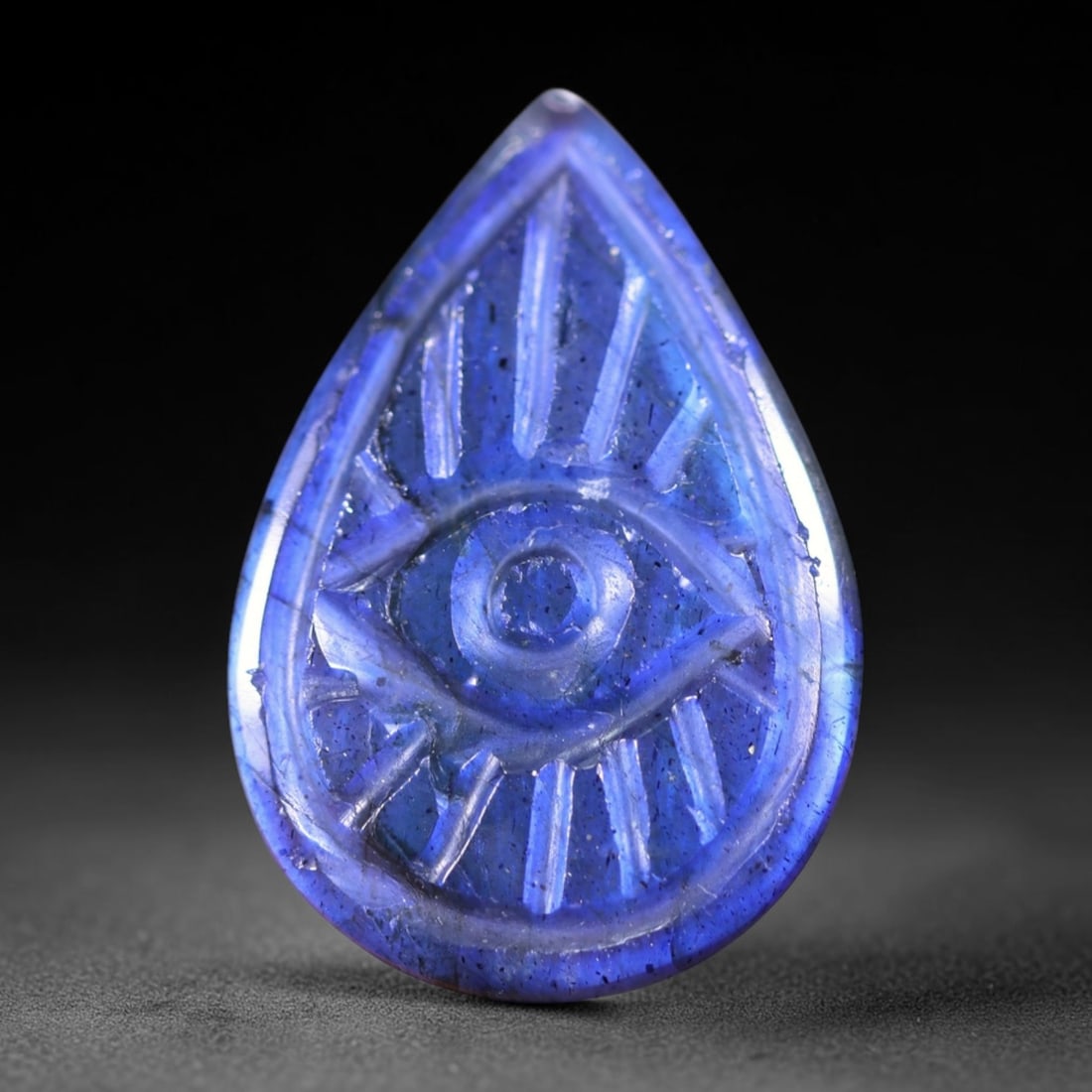 14.24cts Labradorite Evil Eye - Carving , 1125E: Ksmith Heritage Auctioneers Subject: Natural Labradorite Origin: India Carat Weight: 14.24cts Dimension: 20.7x14.2x5.6 mm Treatment: Unheated Type: Carving