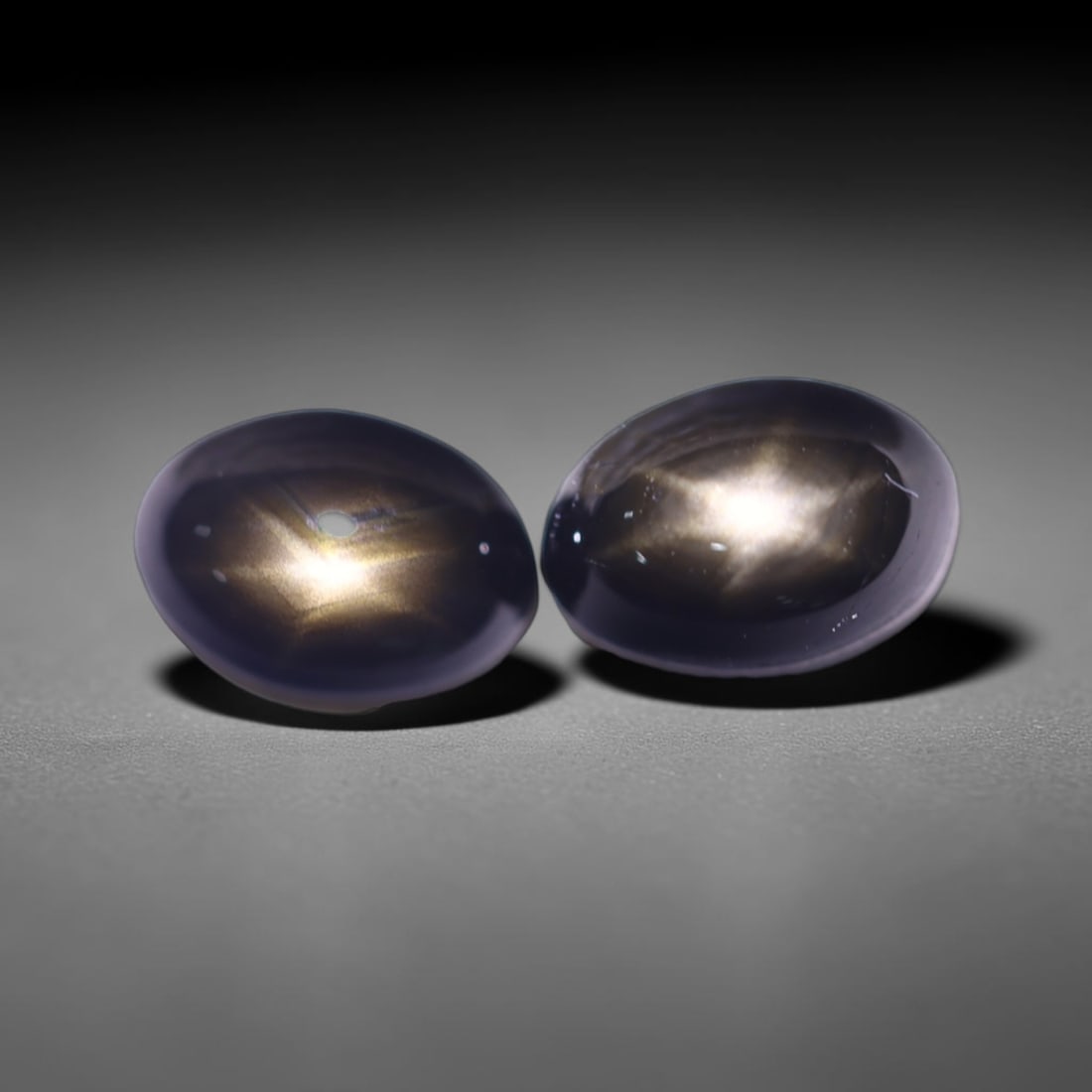 2.86cts 6 Rays Black Star Sapphire Pair , 568E: Ksmith Heritage Auctioneers Subject: Natural 6 Rays Star Sapphire Origin: Myanmar Carat Weight: 2.86cts Dimension: 7x4.9x3.1 mm Treatment: Diffusion Type: Cabochon, Polish