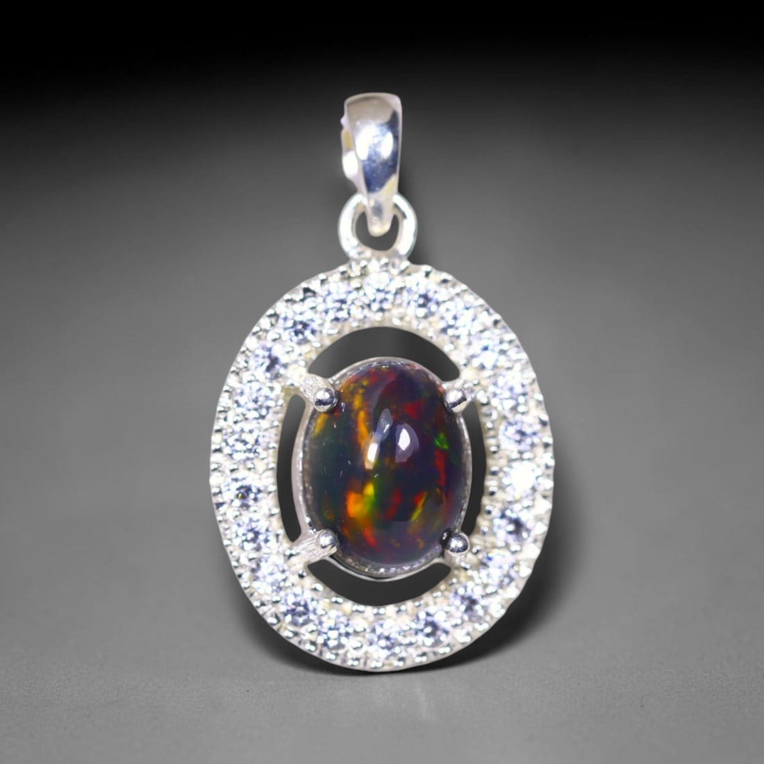 Silver Pendant with Ethiopian Black Opal 3.5grams - 925 Sterling Silver , 85E: Ksmith Heritage Auctioneers Subject: Opal & Simulated Diamond Silver Pendant Carat Weight: 3.5 grams (approx.) Dimension: Opal 10x7mm, Pendant 22x15mm