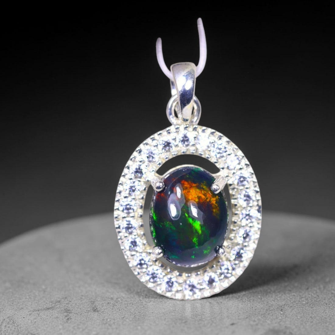 Silver Pendant with Ethiopian Black Opal 3.5grams - 925 Sterling Silver , 663E: Ksmith Heritage Auctioneers Subject: Opal & Simulated Diamond Silver Pendant Carat Weight: 3.5 grams (approx.) Dimension: Opal 10x7mm, Pendant 22x15mm