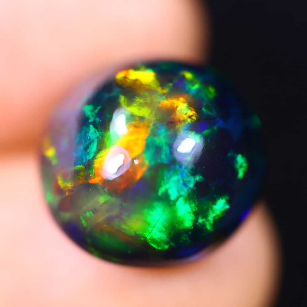 *8.43Ct Welo Black Opal Polished - Ethiopian Opal - Round Cabochon , 60E: Ksmith Heritage Auctioneers Subject: Natural Ethiopian Welo Black Opal Origin: Ethiopia Carat Weight: 8.43Ct Dimension: 14 x 13.9 x 8.7 mm Treatment: Smoked Shape: Round