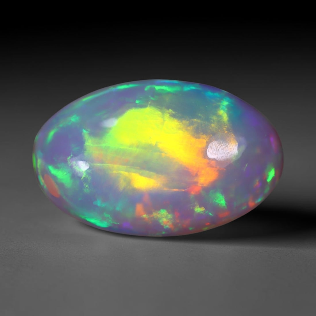*6.21Ct Welo Opal Polished - Ethiopian Opal , 879E: Ksmith Heritage Auctioneers Subject: Natural Ethiopian Welo Opal Origin: Ethiopia Carat Weight: 6.21Ct Dimension: 17.3x10.9x6 mm Treatment: Natural Untreated Type: Cabocho