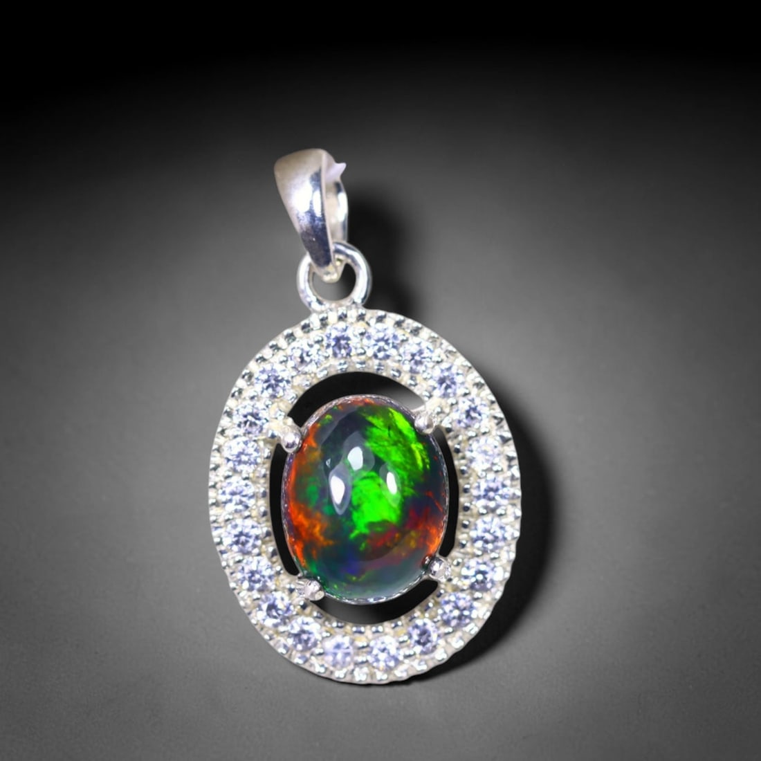 Silver Pendant with Ethiopian Black Opal 3.5grams - 925 Sterling Silver , 1062E: Ksmith Heritage Auctioneers Subject: Opal & Simulated Diamond Silver Pendant Carat Weight: 3.5 grams (approx.) Dimension: Opal 10x7mm, Pendant 22x15mm