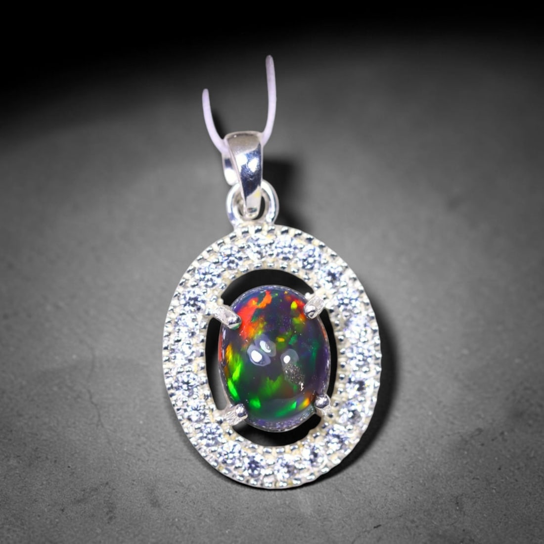 Silver Pendant with Ethiopian Black Opal 3.5grams - 925 Sterling Silver , 245E: Ksmith Heritage Auctioneers Subject: Opal & Simulated Diamond Silver Pendant Carat Weight: 3.5 grams (approx.) Dimension: Opal 10x7mm, Pendant 22x15mm