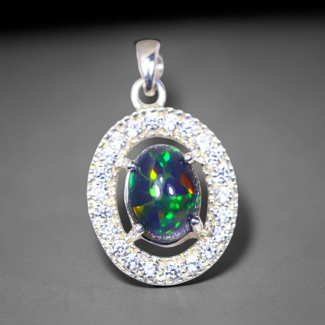Silver Pendant with Ethiopian Black Opal 3.5grams - 925 Sterling Silver , 10E: Ksmith Heritage Auctioneers Subject: Opal & Simulated Diamond Silver Pendant Carat Weight: 3.5 grams (approx.) Dimension: Opal 10x7mm, Pendant 22x15mm