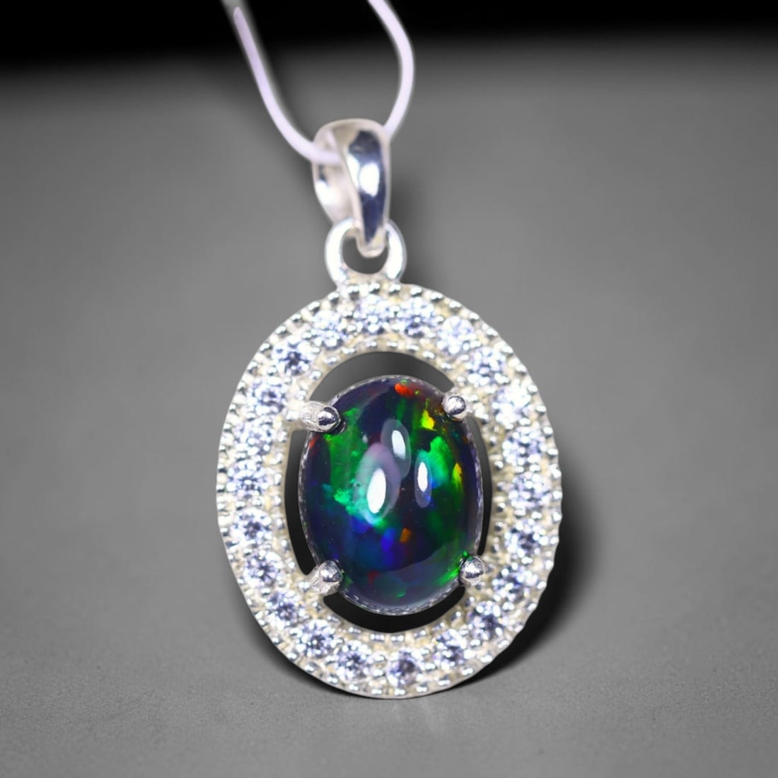 Silver Pendant with Ethiopian Black Opal 3.5grams - 925 Sterling Silver, 949B: Ksmith Heritage Auctioneers Subject: Opal & Simulated Diamond Silver Pendant Carat Weight: 3.5 grams (approx.) Dimension: Opal 10x7mm, Pendant 22x15mm