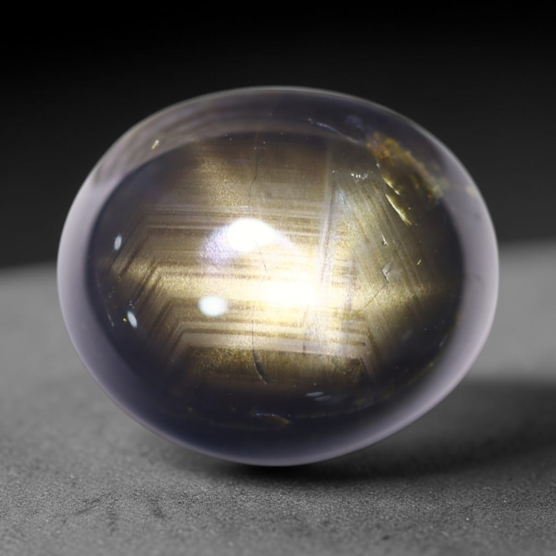 7.90cts 6 Rays Black Star Sapphire , 745E: Ksmith Heritage Auctioneers Subject: Natural 6 Rays Star Sapphire Origin: Myanmar Carat Weight: 7.90cts Dimension: 11.5x9.7x5.7 mm Treatment: Diffusion Type: Cabochon, Pol