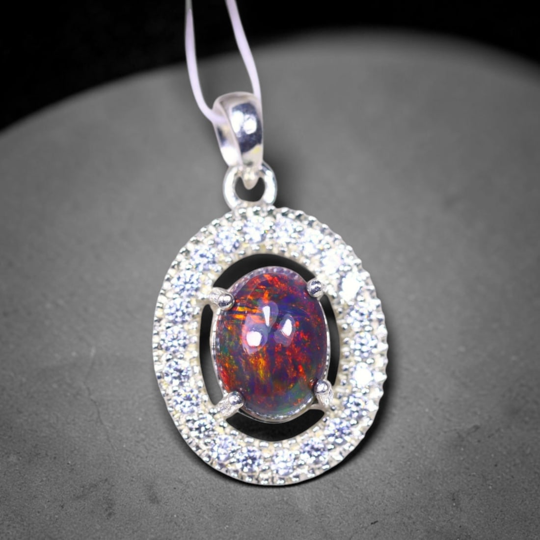 Silver Pendant with Ethiopian Black Opal 3.5grams - 925 Sterling Silver , 198E: Ksmith Heritage Auctioneers Subject: Opal & Simulated Diamond Silver Pendant Carat Weight: 3.5 grams (approx.) Dimension: Opal 10x7mm, Pendant 22x15mm
