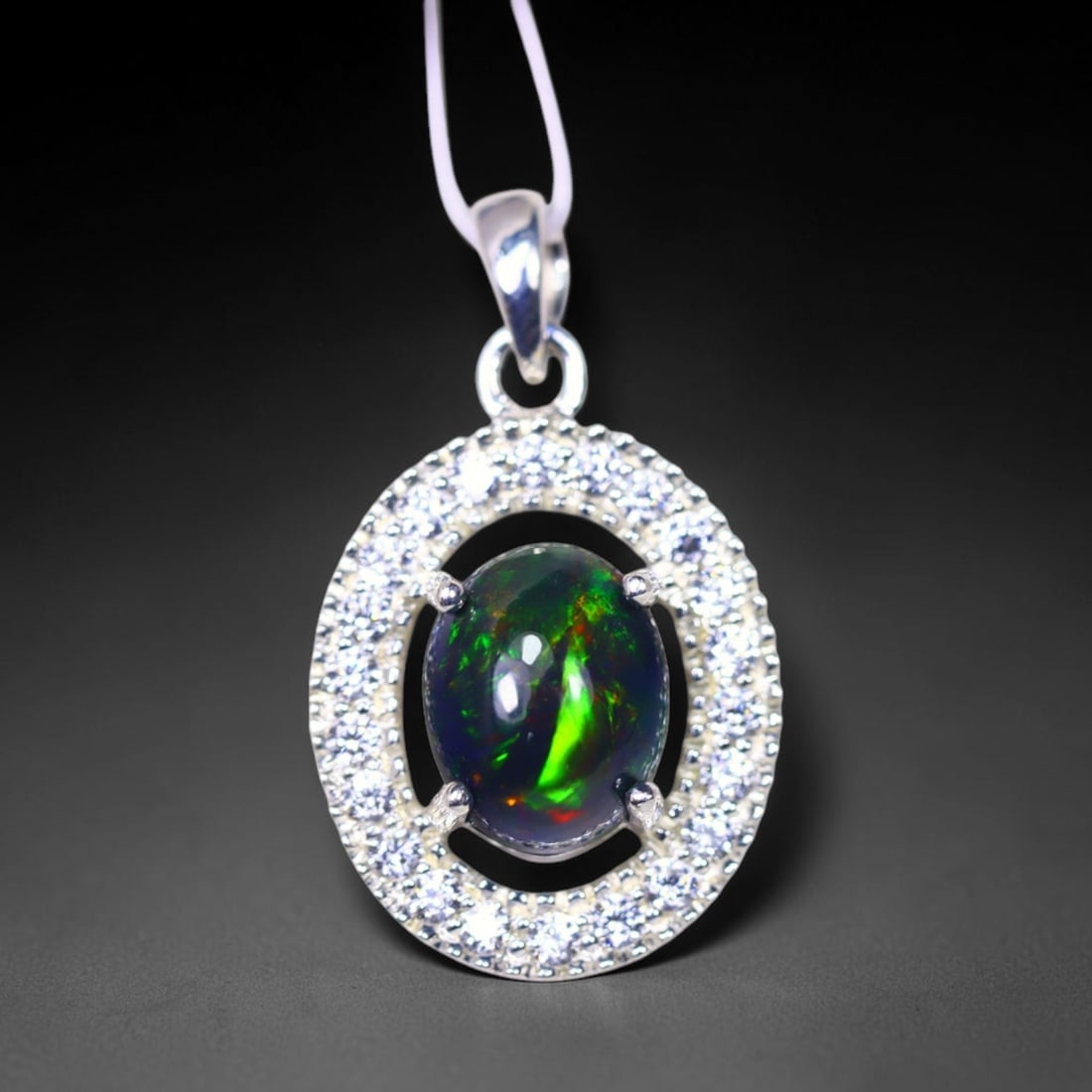 Silver Pendant with Ethiopian Black Opal 3.5grams - 925 Sterling Silver, 384B: Ksmith Heritage Auctioneers Subject: Opal & Simulated Diamond Silver Pendant Carat Weight: 3.5 grams (approx.) Dimension: Opal 10x7mm, Pendant 22x15mm