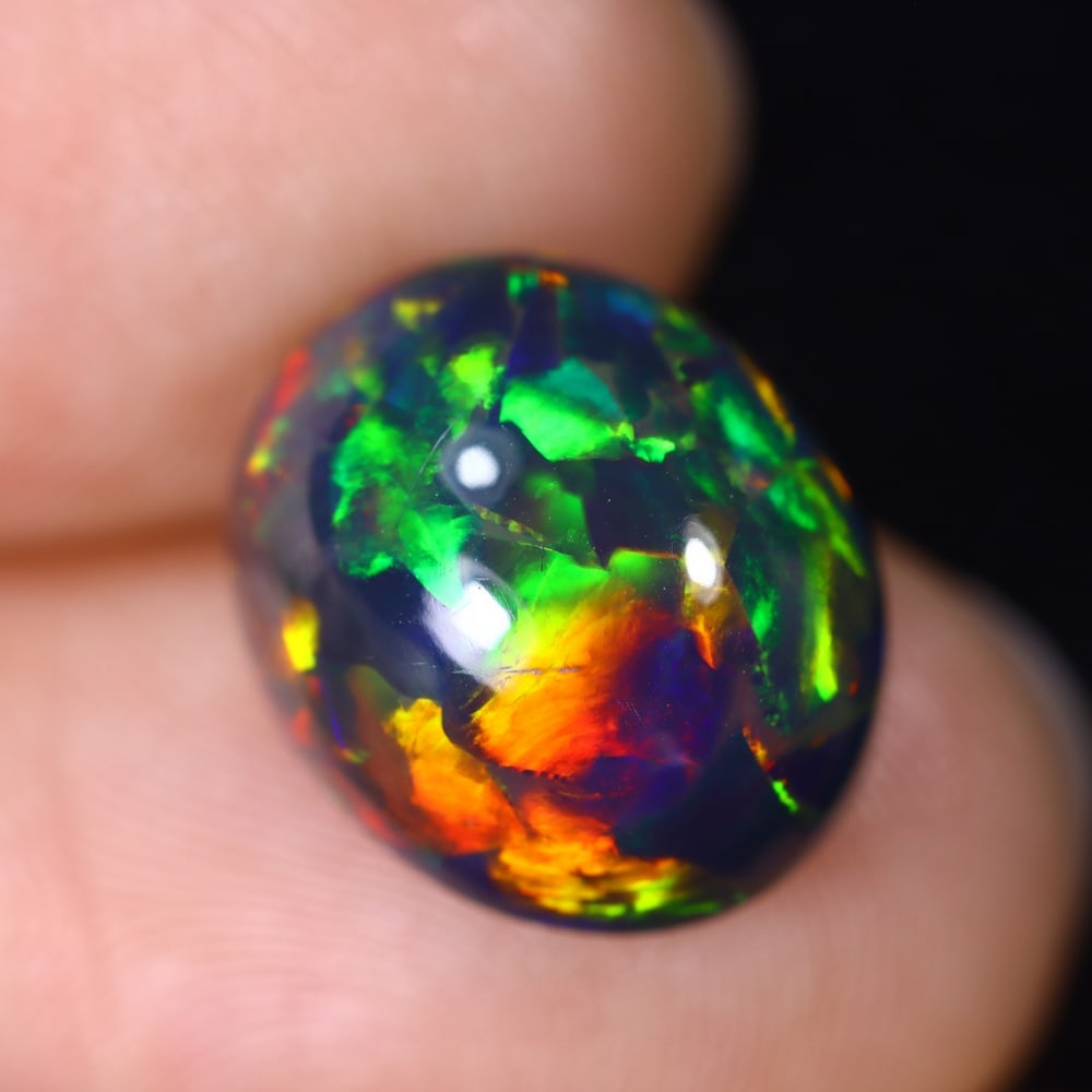 4.87Ct Natural Ethiopian Black Opal - 13.0x10.8x7.2 mm , 575C: Ksmith Heritage Auctioneers Subject: Natural Ethiopian Welo Opal Origin: Ethiopia Treatment: Smoked