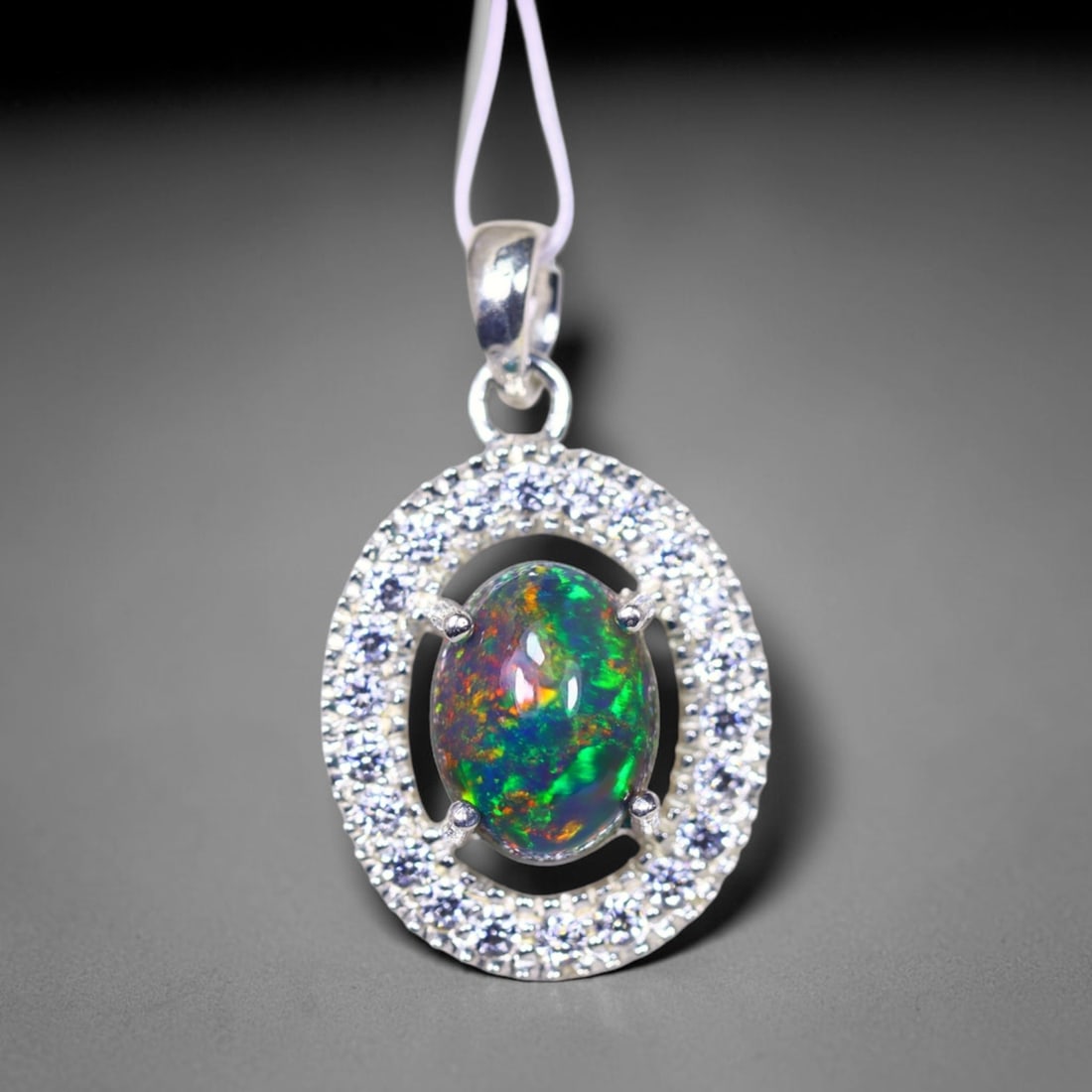 Silver Pendant with Ethiopian Black Opal 3.5grams - 925 Sterling Silver , 699E: Ksmith Heritage Auctioneers Subject: Opal & Simulated Diamond Silver Pendant Carat Weight: 3.5 grams (approx.) Dimension: Opal 10x7mm, Pendant 22x15mm