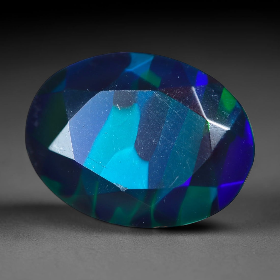 2.40Ct Natural Smoked Ethiopian Black Opal, Faceted Cut - 12.0x9.1x5.0 mm , 701C: Ksmith Heritage Auctioneers Subject: Natural Ethiopian Welo Opal Origin: Ethiopia Treatment: Smoked