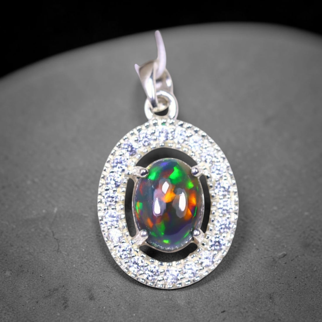 Silver Pendant with Ethiopian Black Opal 3.5grams - 925 Sterling Silver , 753E: Ksmith Heritage Auctioneers Subject: Opal & Simulated Diamond Silver Pendant Carat Weight: 3.5 grams (approx.) Dimension: Opal 10x7mm, Pendant 22x15mm